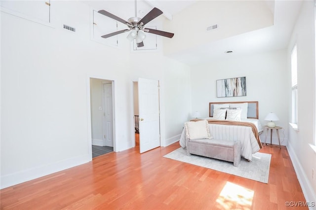 6 S Rowland St, Richmond, VA 23220 - bedroom featuring visible vents, a towering ceiling, wood finished floors, and multiple windows