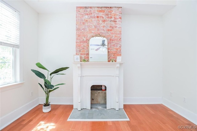 6 S Rowland St, Richmond, VA 23220 - unfurnished living room with baseboards, wood finished floors, a fireplace, and ceiling fan