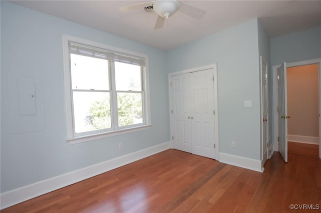 6 S Rowland St, Richmond, VA 23220 - unfurnished bedroom with baseboards, wood finished floors, multiple windows, and a closet