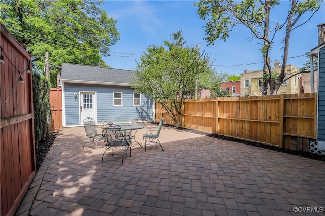 6 S Rowland St, Richmond, VA 23220 - view of patio featuring a fenced backyard, an outdoor structure, and outdoor dining area