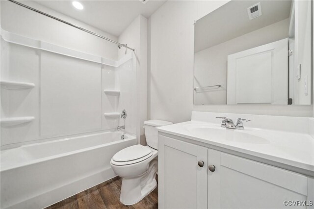 bathroom with wood finished floors, visible vents, toilet, vanity, and shower / tub combination