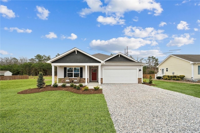view of front of home with a porch, driveway, fence, and a garage