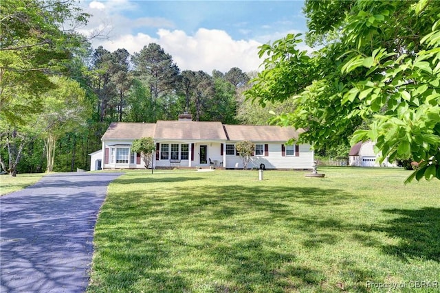 single story home featuring a front yard and aphalt driveway