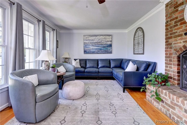 living room with wood finished floors, a wealth of natural light, and crown molding