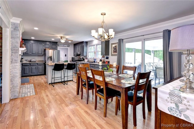 dining room featuring light wood finished floors, recessed lighting, ornamental molding, and ceiling fan with notable chandelier
