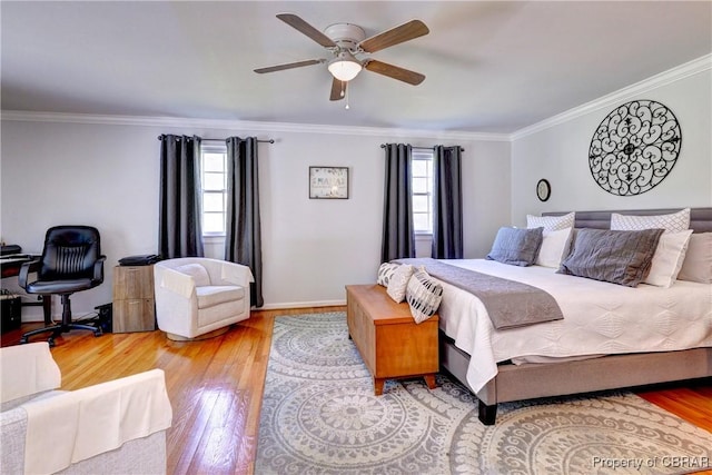 bedroom featuring wood finished floors, a ceiling fan, baseboards, and ornamental molding