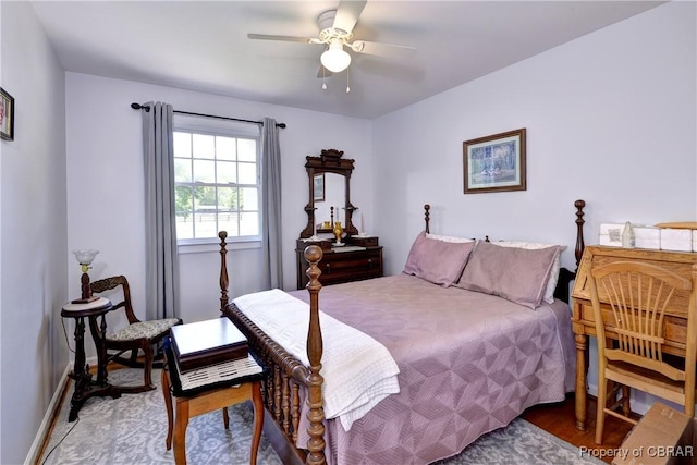 bedroom with baseboards, a ceiling fan, and light wood finished floors