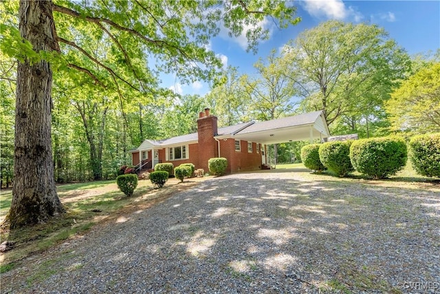 8000 N Courthouse Rd, New Kent, VA 23124 - ranch-style house featuring brick siding, driveway, a chimney, and a carport