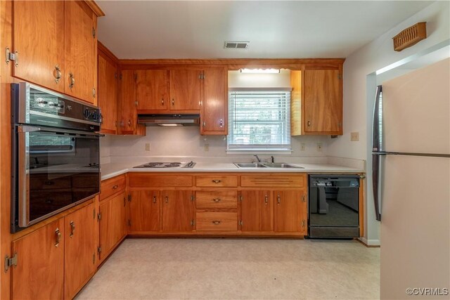 8000 N Courthouse Rd, New Kent, VA 23124 - kitchen featuring black appliances, a sink, brown cabinetry, and light countertops