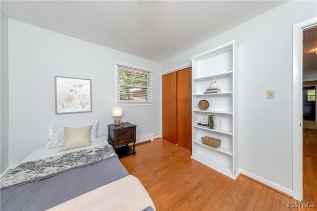 8000 N Courthouse Rd, New Kent, VA 23124 - bedroom with baseboards, a closet, a baseboard radiator, and light wood-style floors