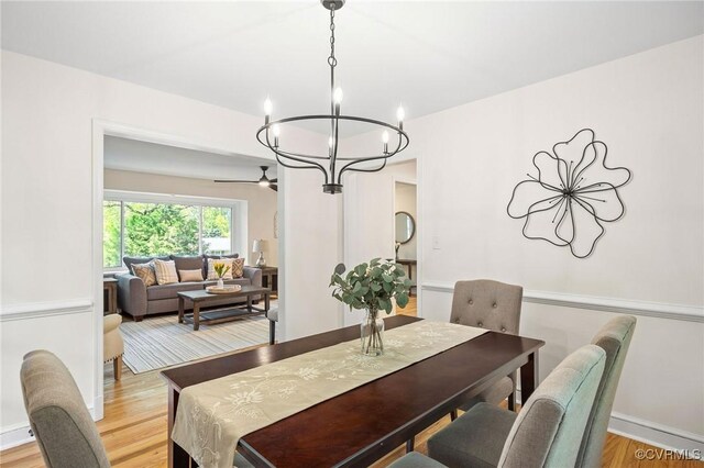 dining area featuring an inviting chandelier and light wood-style floors
