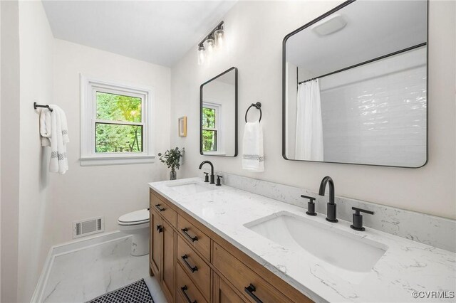 full bathroom featuring marble finish floor, toilet, a sink, and visible vents