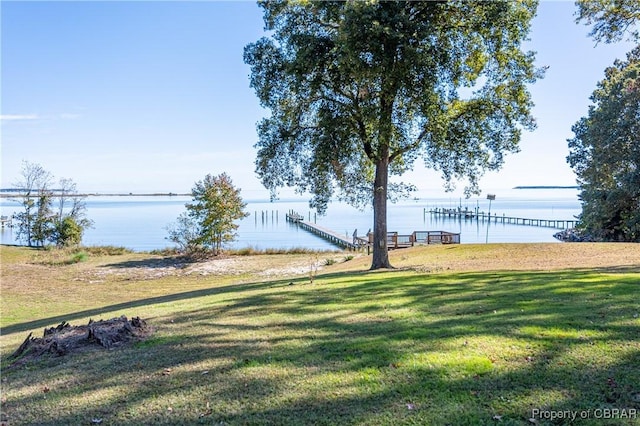 view of yard with a boat dock and a water view