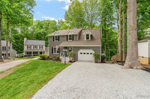 view of front of property with gravel driveway, an attached garage, a front yard, and roof with shingles