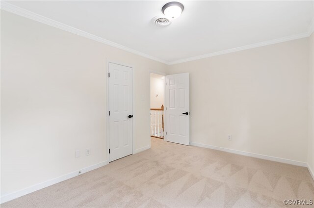 carpeted empty room featuring ornamental molding and baseboards