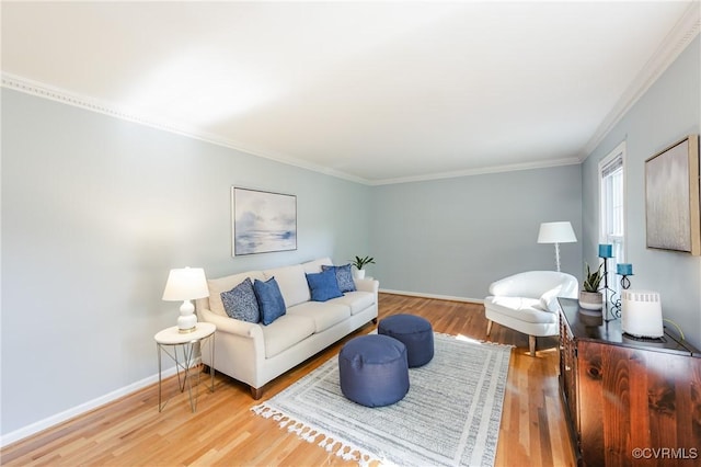 living room with crown molding, baseboards, and wood finished floors