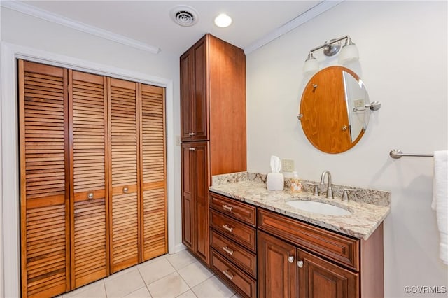 bathroom featuring visible vents, crown molding, a closet, vanity, and tile patterned floors