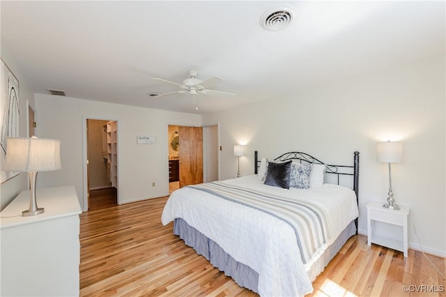bedroom with visible vents, a ceiling fan, baseboards, and light wood-type flooring