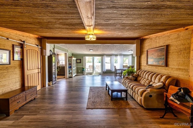 living area featuring a barn door, wooden walls, wood ceiling, and dark wood-style flooring