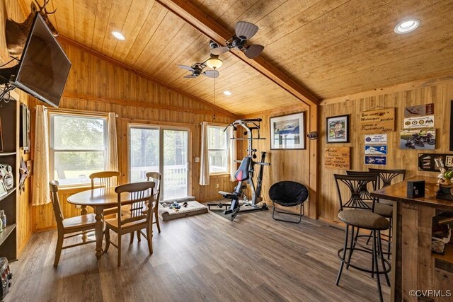 workout room with lofted ceiling, wooden walls, wood finished floors, wooden ceiling, and ceiling fan