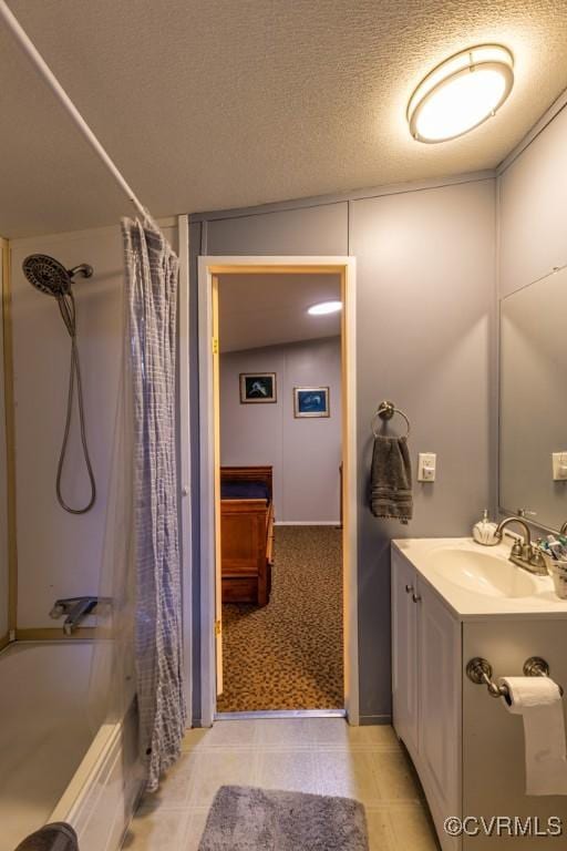 bathroom featuring shower / bath combo, vanity, and a textured ceiling