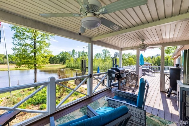 wooden deck featuring outdoor dining space, a water view, and ceiling fan