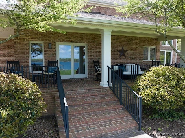 entrance to property featuring brick siding