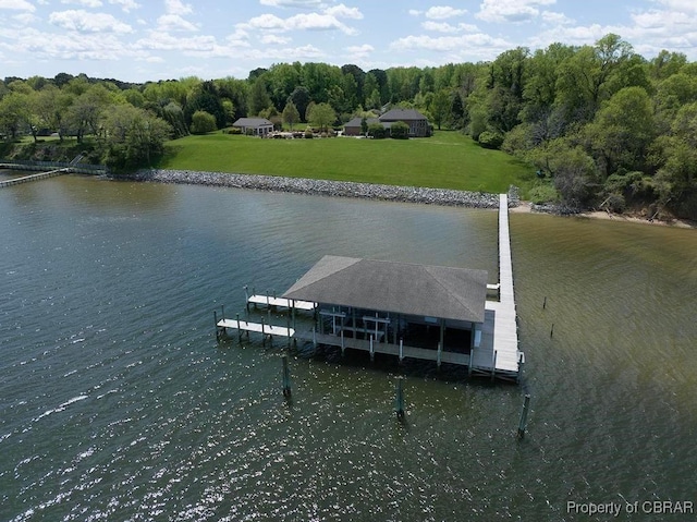 dock area with a yard, a water view, and boat lift