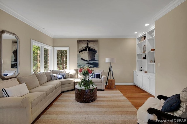 living area featuring recessed lighting, light wood-style flooring, crown molding, and baseboards