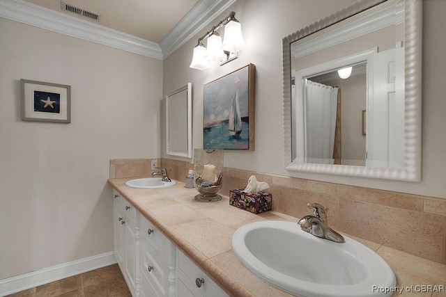 bathroom featuring double vanity, visible vents, ornamental molding, and a sink
