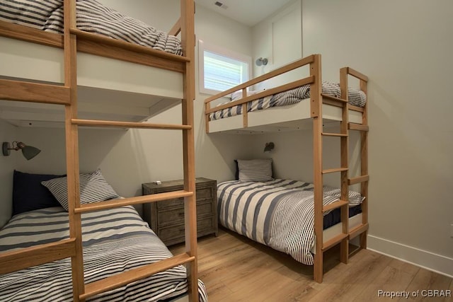 bedroom featuring wood finished floors and baseboards