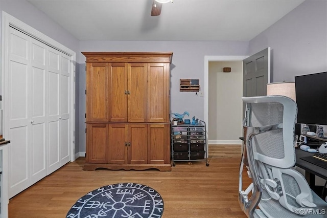 office with light wood-type flooring, ceiling fan, and baseboards