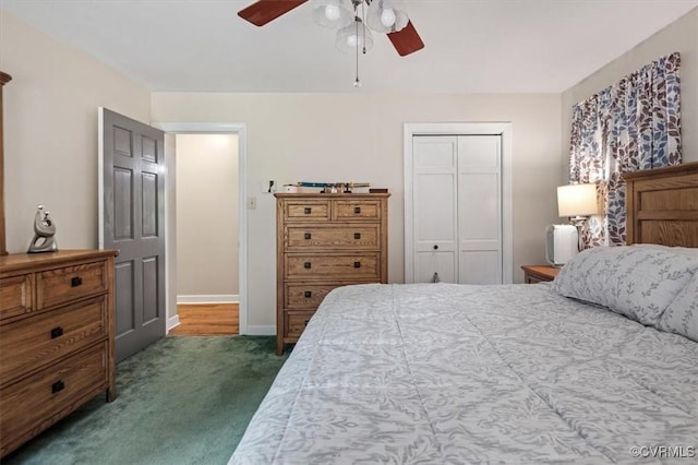 bedroom with dark carpet, a closet, baseboards, and a ceiling fan