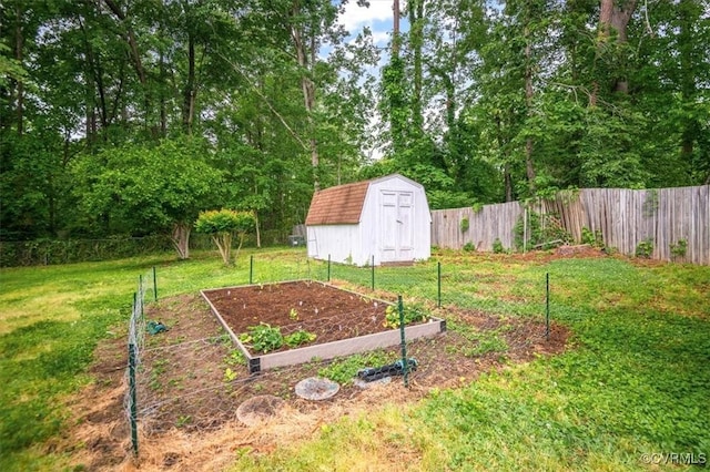 view of yard featuring a vegetable garden, a storage shed, and an outdoor structure