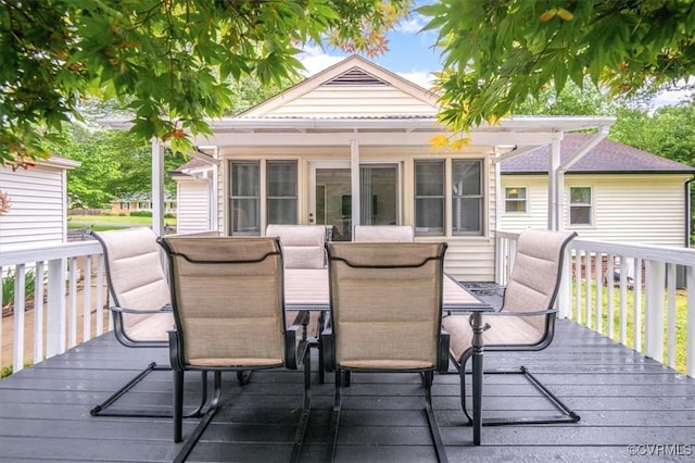 wooden deck featuring outdoor dining area