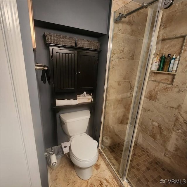 full bath featuring a shower stall and toilet