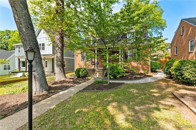 view of front of property with fence and brick siding