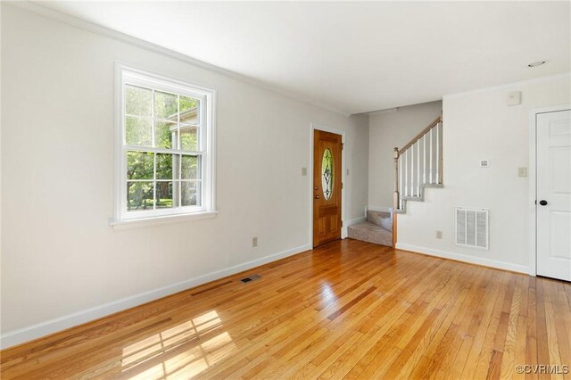 interior space featuring visible vents, light wood-type flooring, and stairs