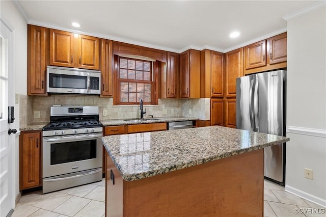 kitchen with light tile patterned flooring, a sink, appliances with stainless steel finishes, and tasteful backsplash