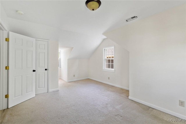 bonus room with carpet flooring, visible vents, lofted ceiling, and baseboards