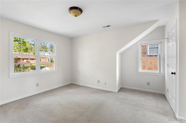 spare room with visible vents, baseboards, and carpet floors