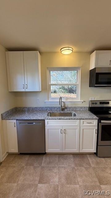 501 Faye St, Richmond, VA 23225 - kitchen with stainless steel appliances, stone counters, a sink, and white cabinetry