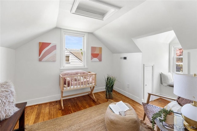 interior space with baseboards, visible vents, wood finished floors, and attic access