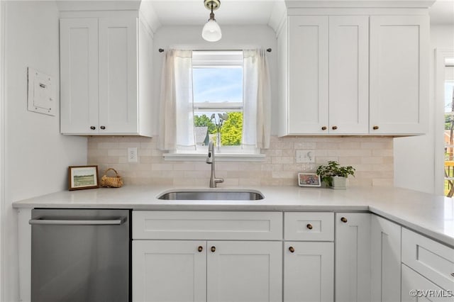 kitchen with a sink, decorative backsplash, dishwasher, and white cabinets