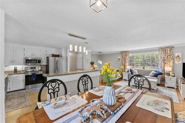 dining space with ornamental molding