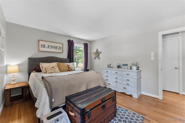 bedroom featuring light wood-style flooring and baseboards