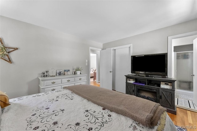 bedroom with a closet and light wood-style flooring