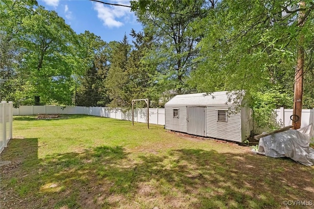 view of yard with an outdoor structure, a storage shed, and a fenced backyard