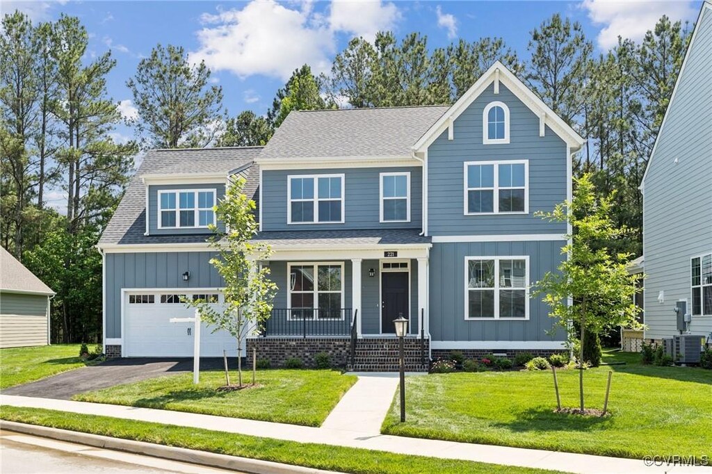 221 Amburn Ln, Ashland, VA 23005 - view of front facade with board and batten siding, asphalt driveway, a porch, a front lawn, and central AC