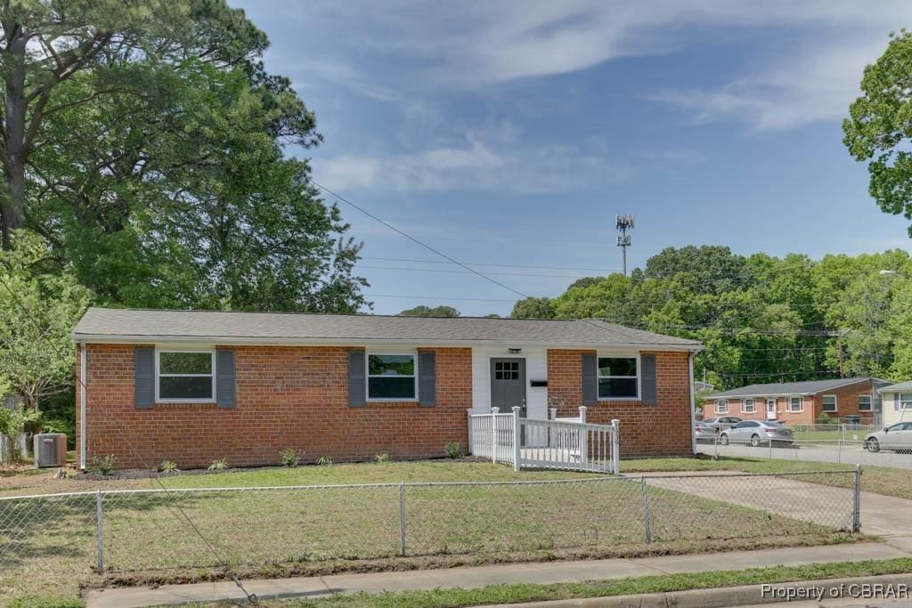 single story home featuring a front lawn, central AC, brick siding, and a fenced front yard